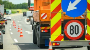 Zwężenie pasa ruchu na autostradzie oznakowane pojazdem drogowym i pachołkami